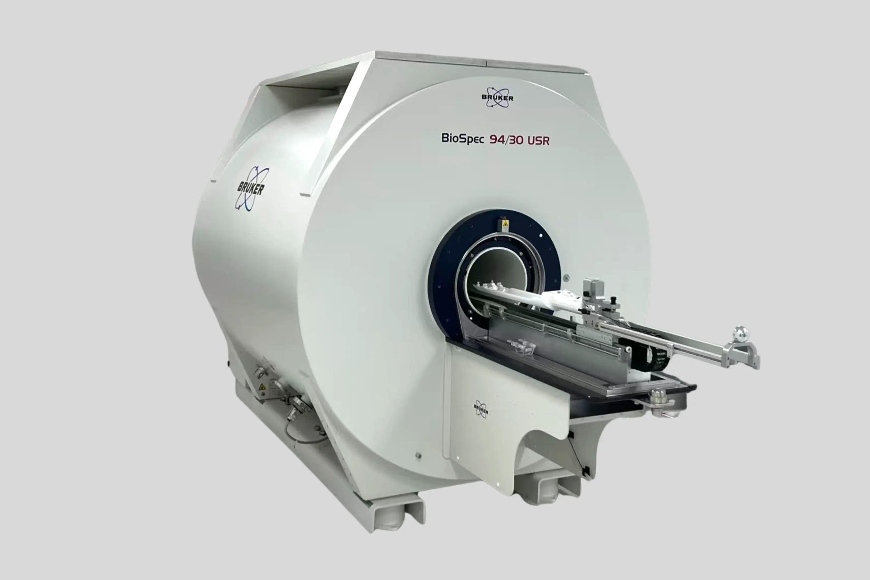 Vector image of the Bruker BioSpec 94/30 MR Scanner with gradient inserts, 1H MRI CryoProbeTM, and PET Insert Si 20/12 on a gray background.