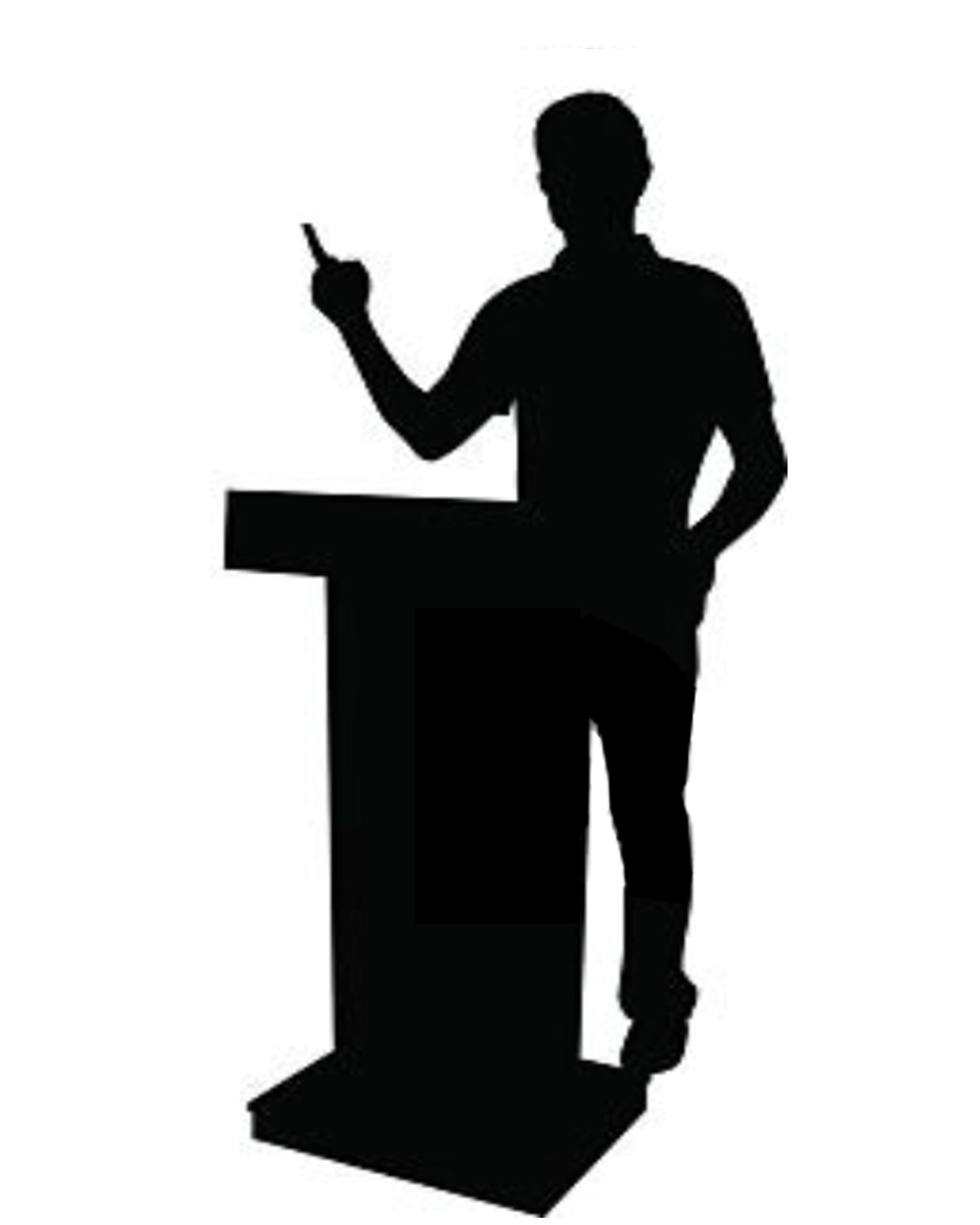 silhouette of a man giving a seminar talk at a podium