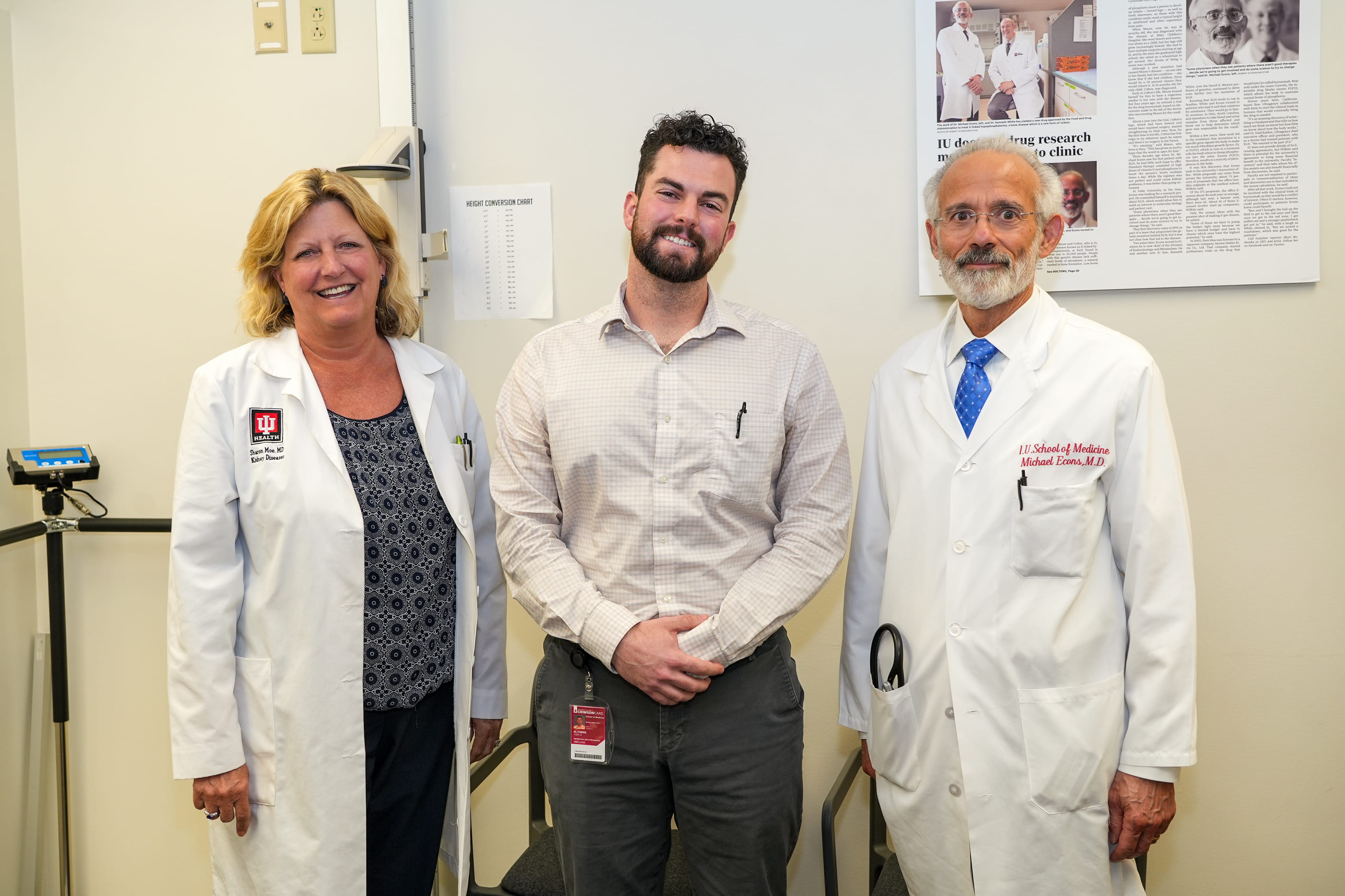 three members of the administrative core team wearing lab coats
