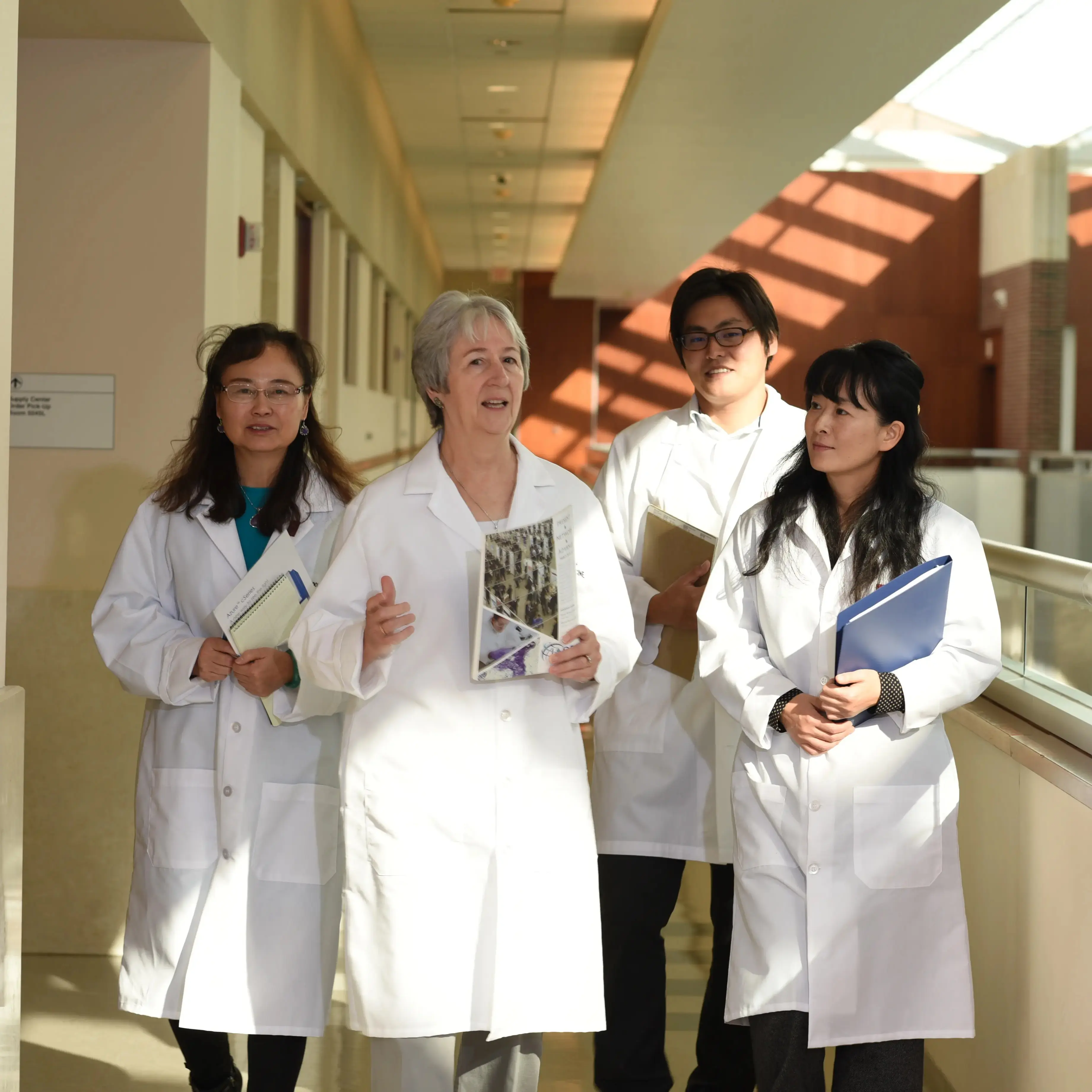 Image of ICMH researchers in white lab coats.