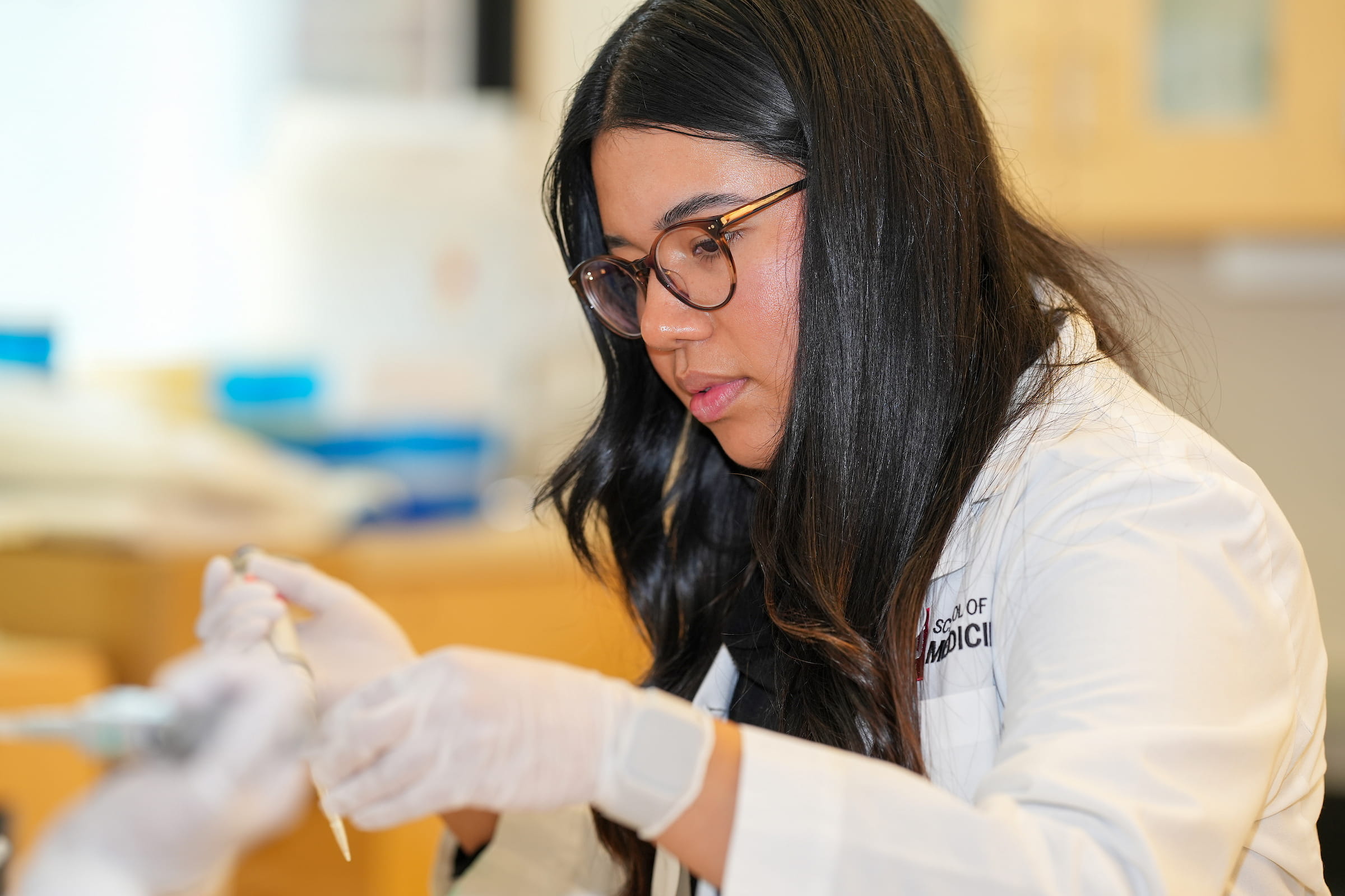 a student prepares a sample in the plotkin lab