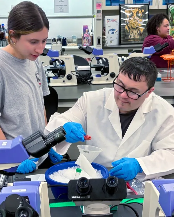 a person with down syndrome works on a lab experiement