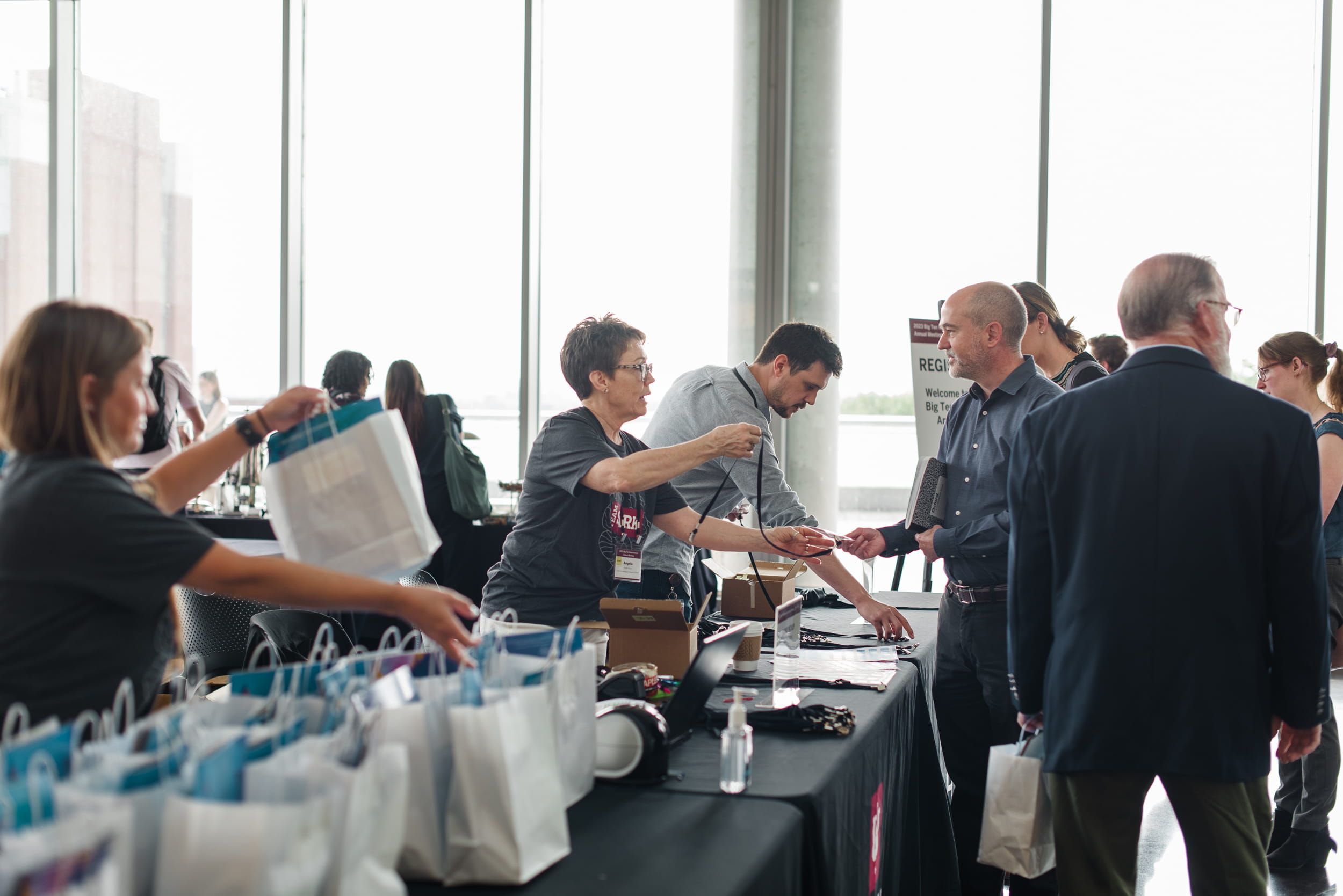 a group of people hand out bags at an event