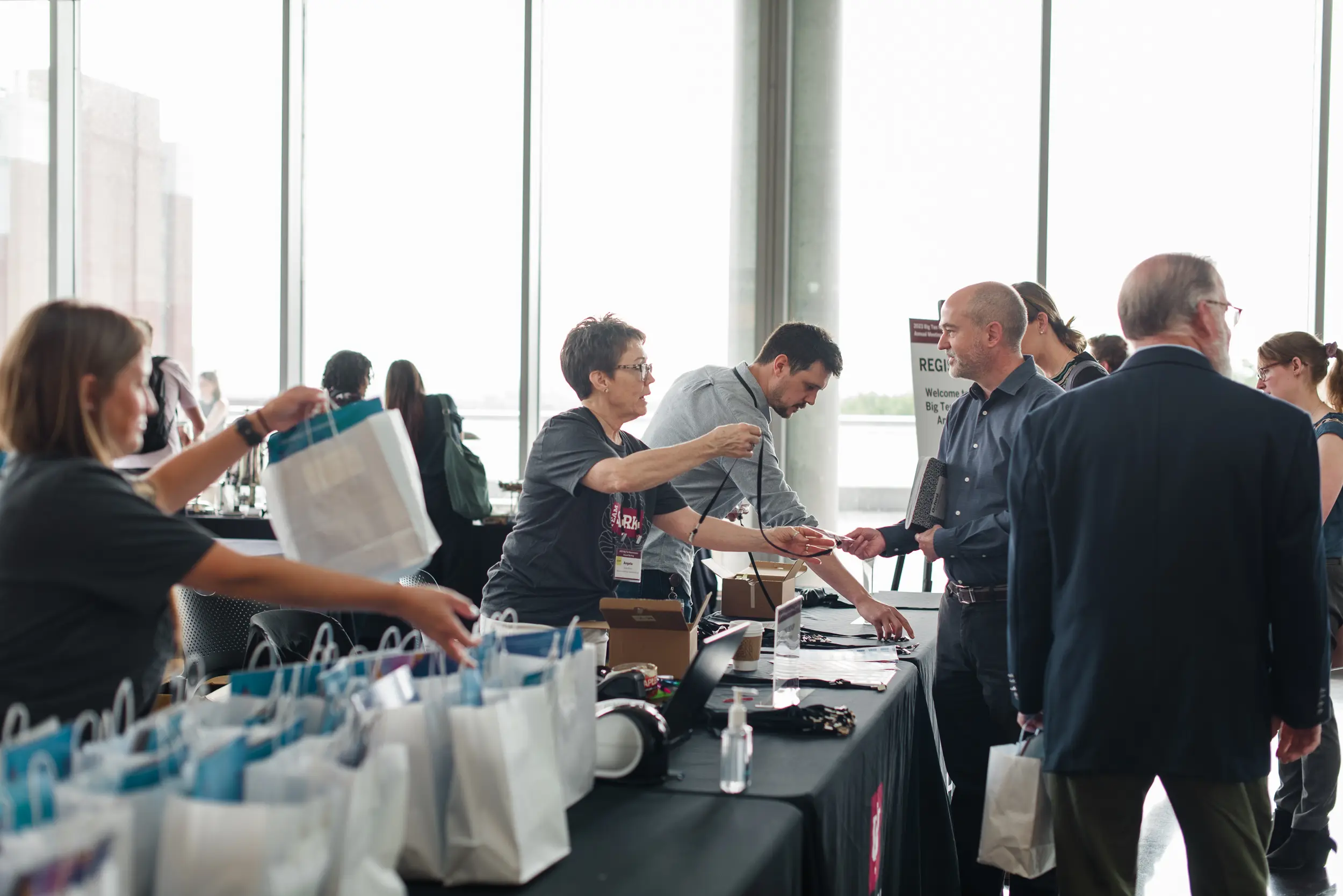a group of people hand out bags at an event