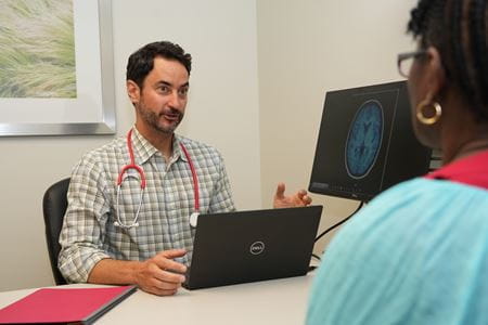 Jared Brosch meets with a clinical trial patient volunteer