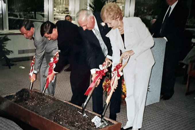 four people break ground at a new research building