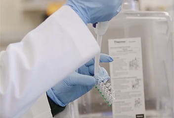 the hands of a researcher holding a tube