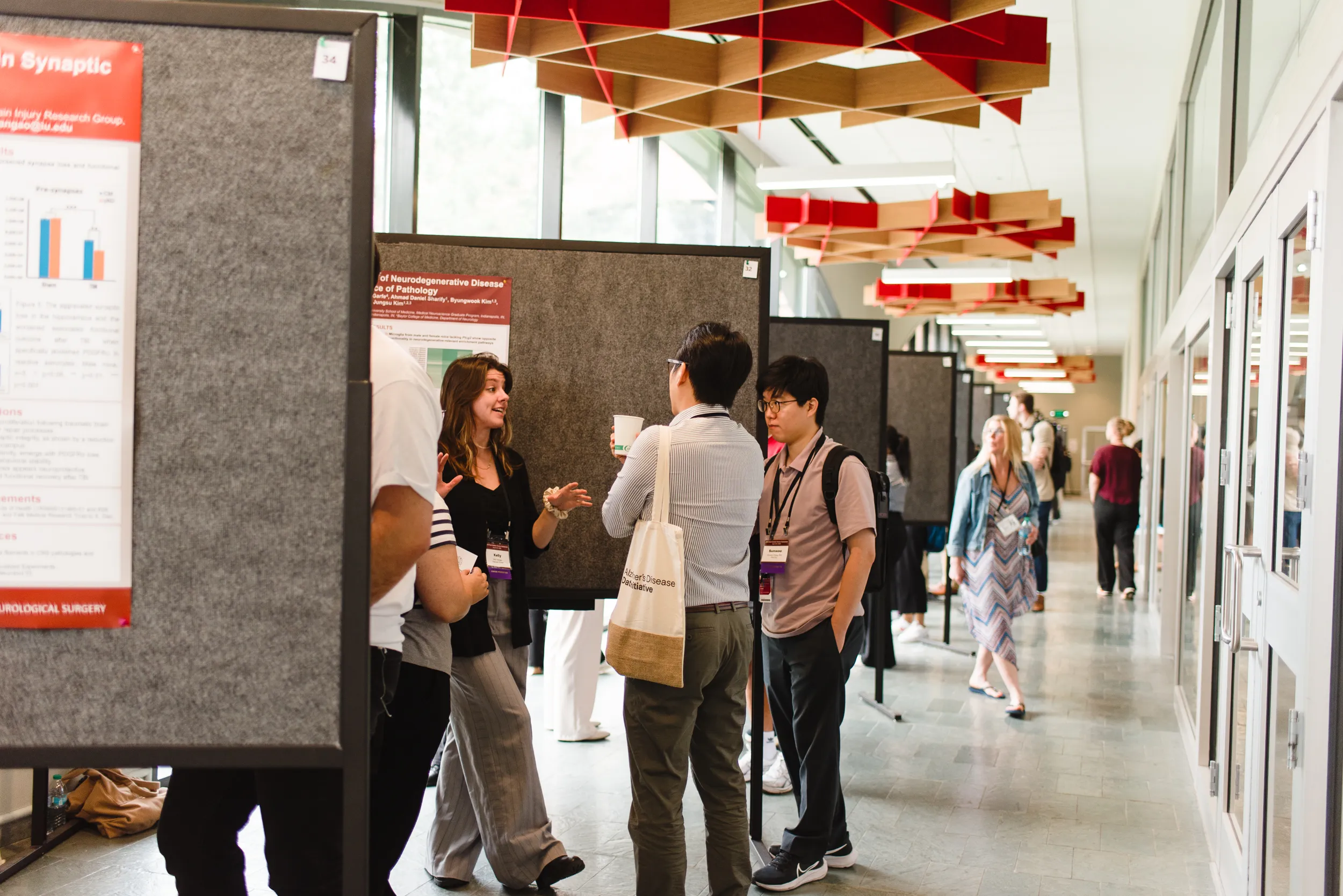 a group of people present research posters