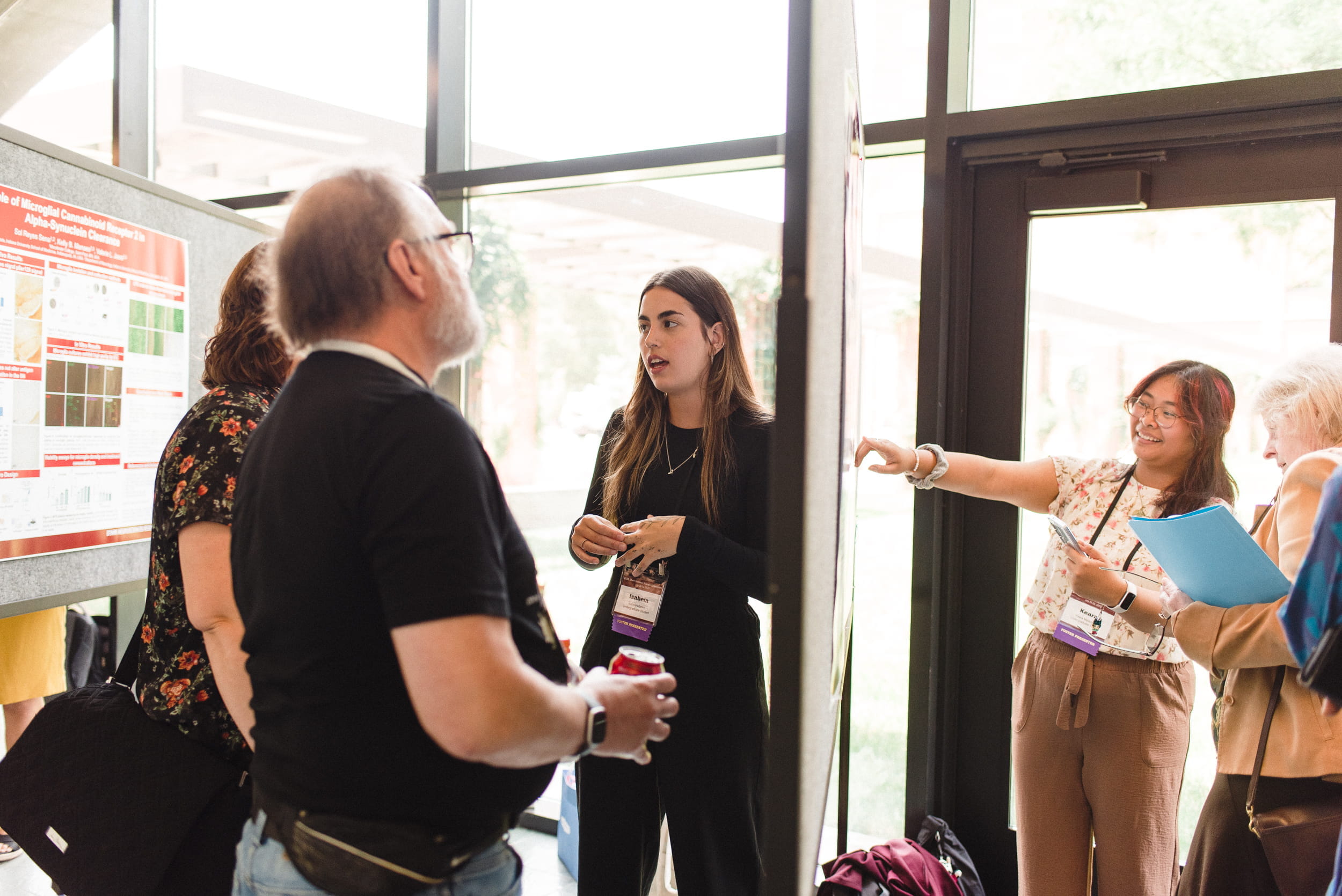 students present posters at a conference