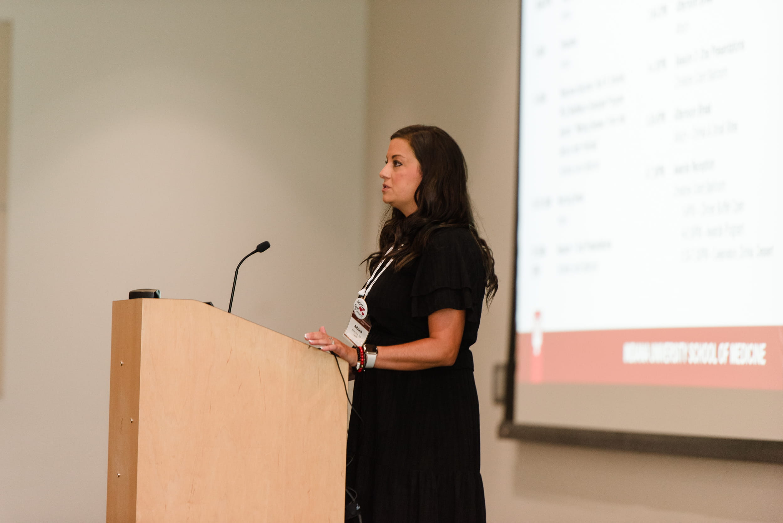 a woman stands at a podium