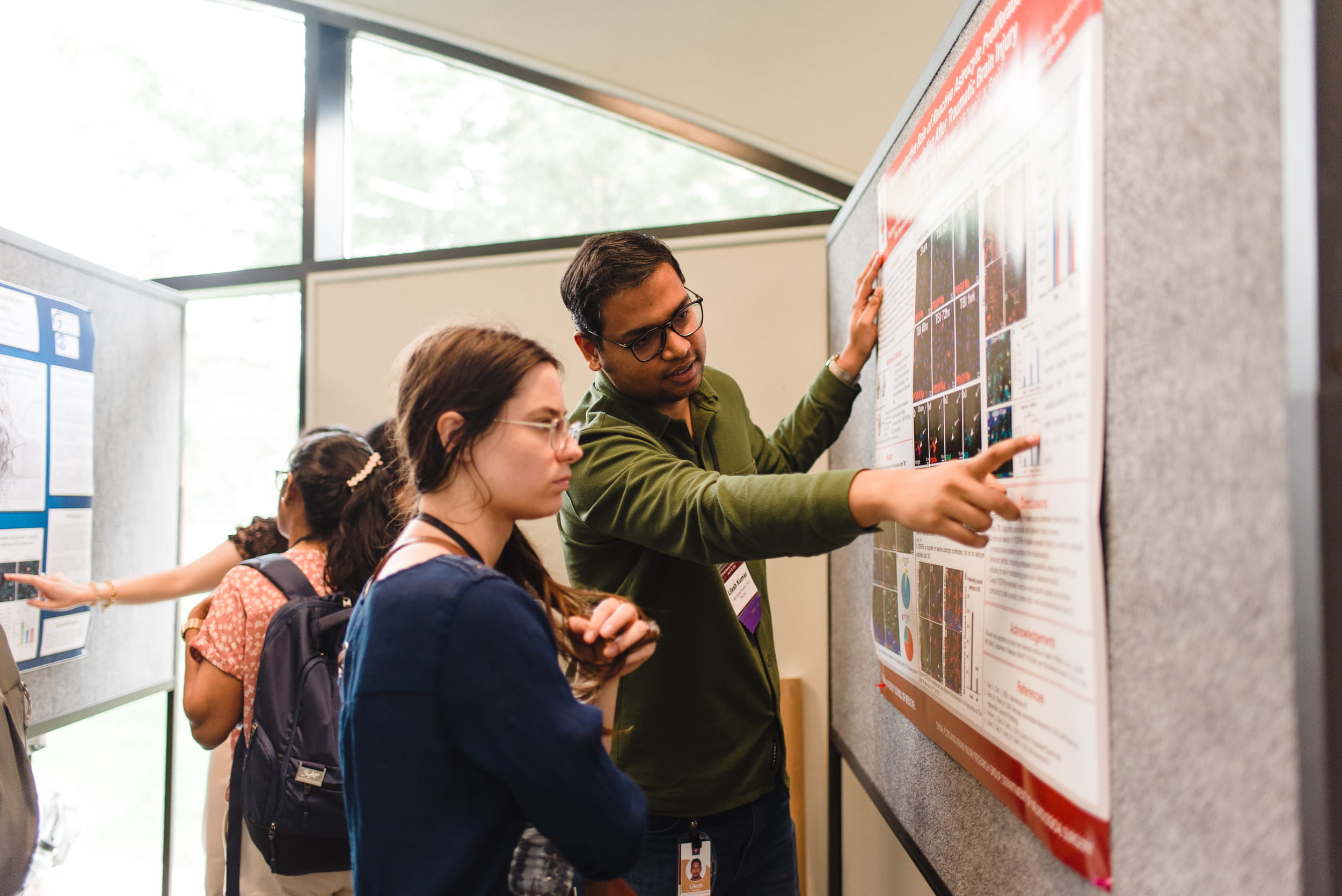 trainees present their research at a symposium