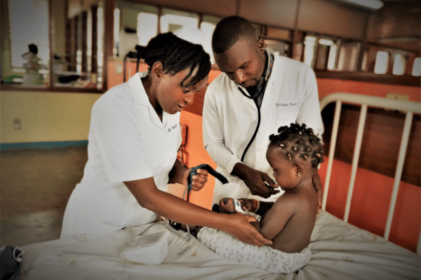 Clinicians at Mulago Hospital in Kampala, Uganda check on a patient