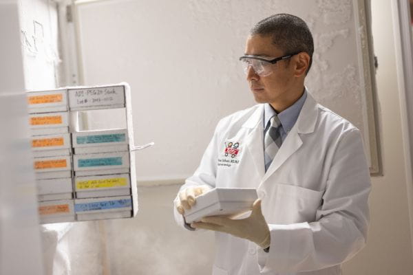 Brian DeBosch pulling study samples from a freezer.