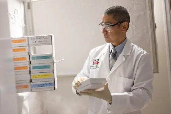 Brian DeBosch pulling study samples from a freezer.