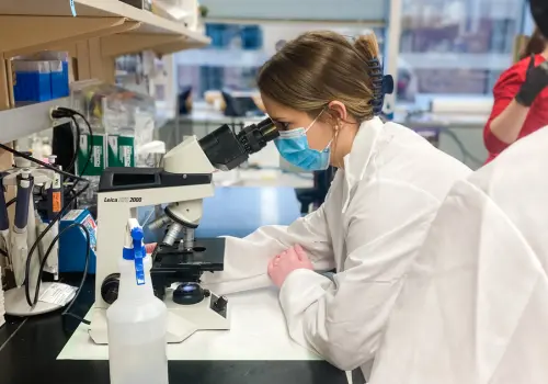 MMIA student looking through a microscope