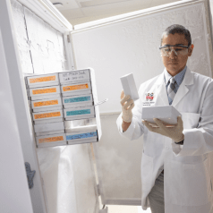 Brian DeBosch, MD, PhD, pulling samples from a freezer in his lab.