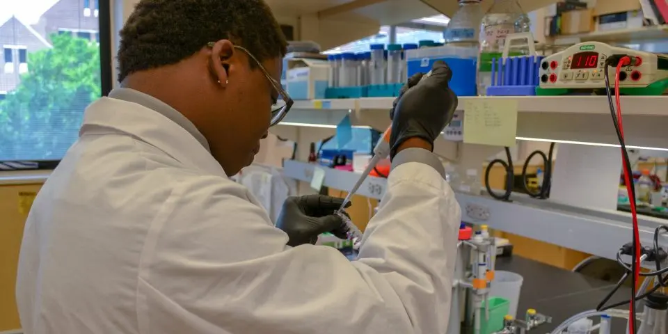 Man pipetting in a lab