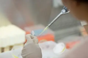 Up close view of a person using a pipette