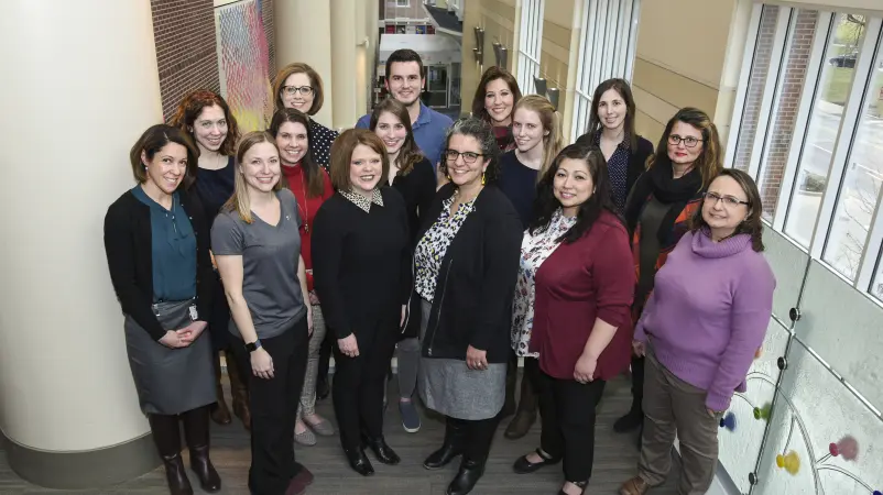 A group of 15 researchers stand together for a team photo