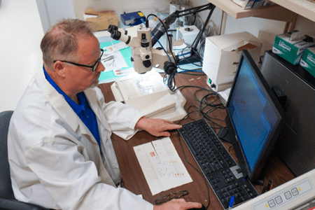 Simon Conway working on a computer in his lab