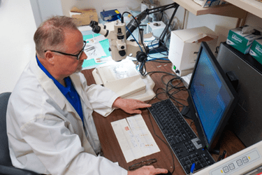 Simon Conway working on a computer in his lab