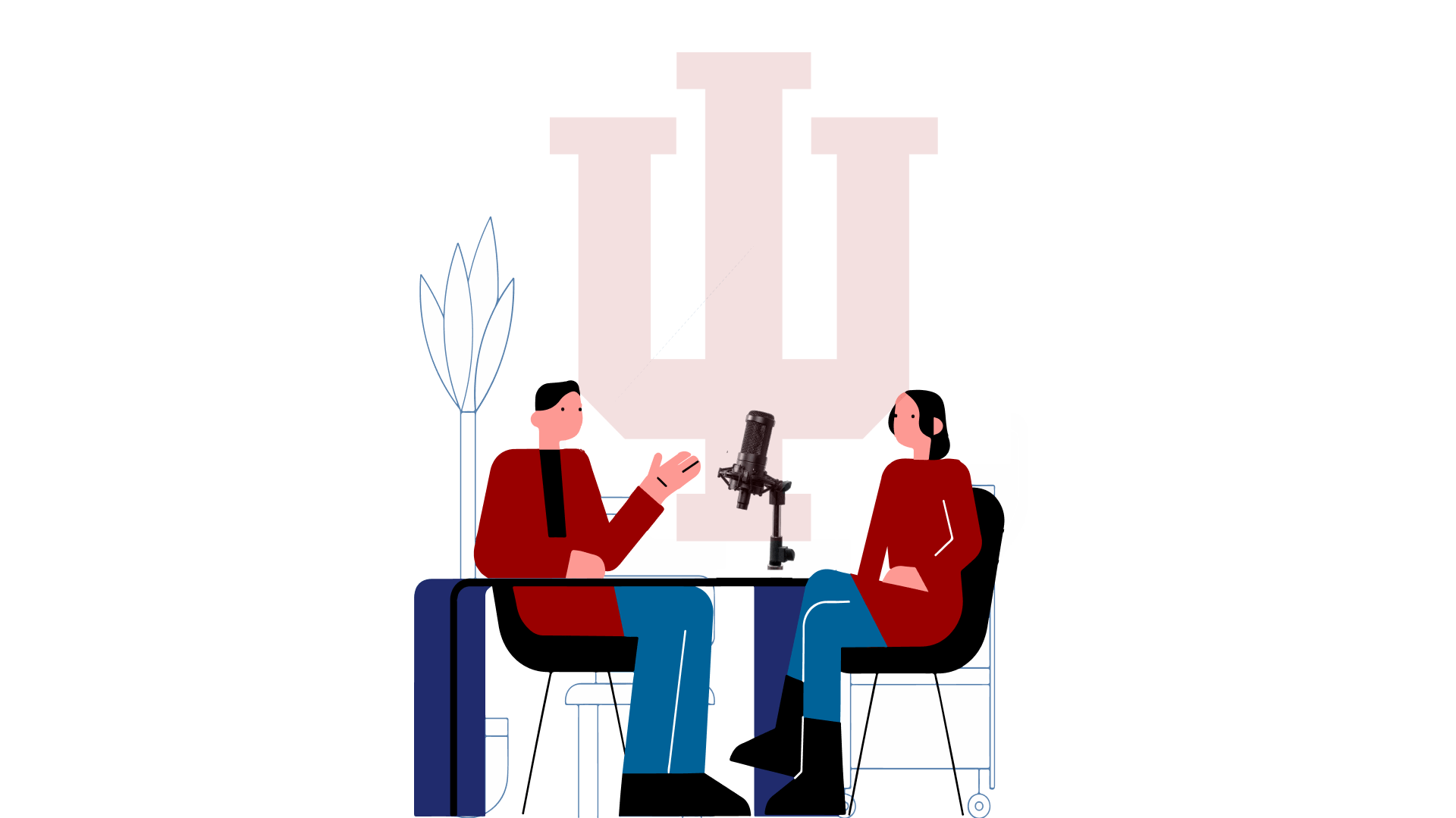 Two people wearing red suit jackets sit infront of the IU Trident speaking into a microphone.