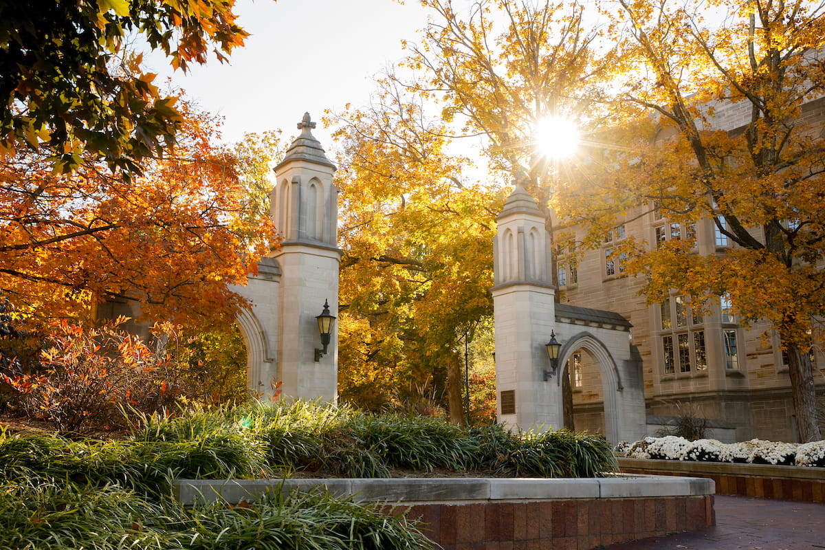 The morning sun shines through the trees surrounding the sample gates in Bloomington.