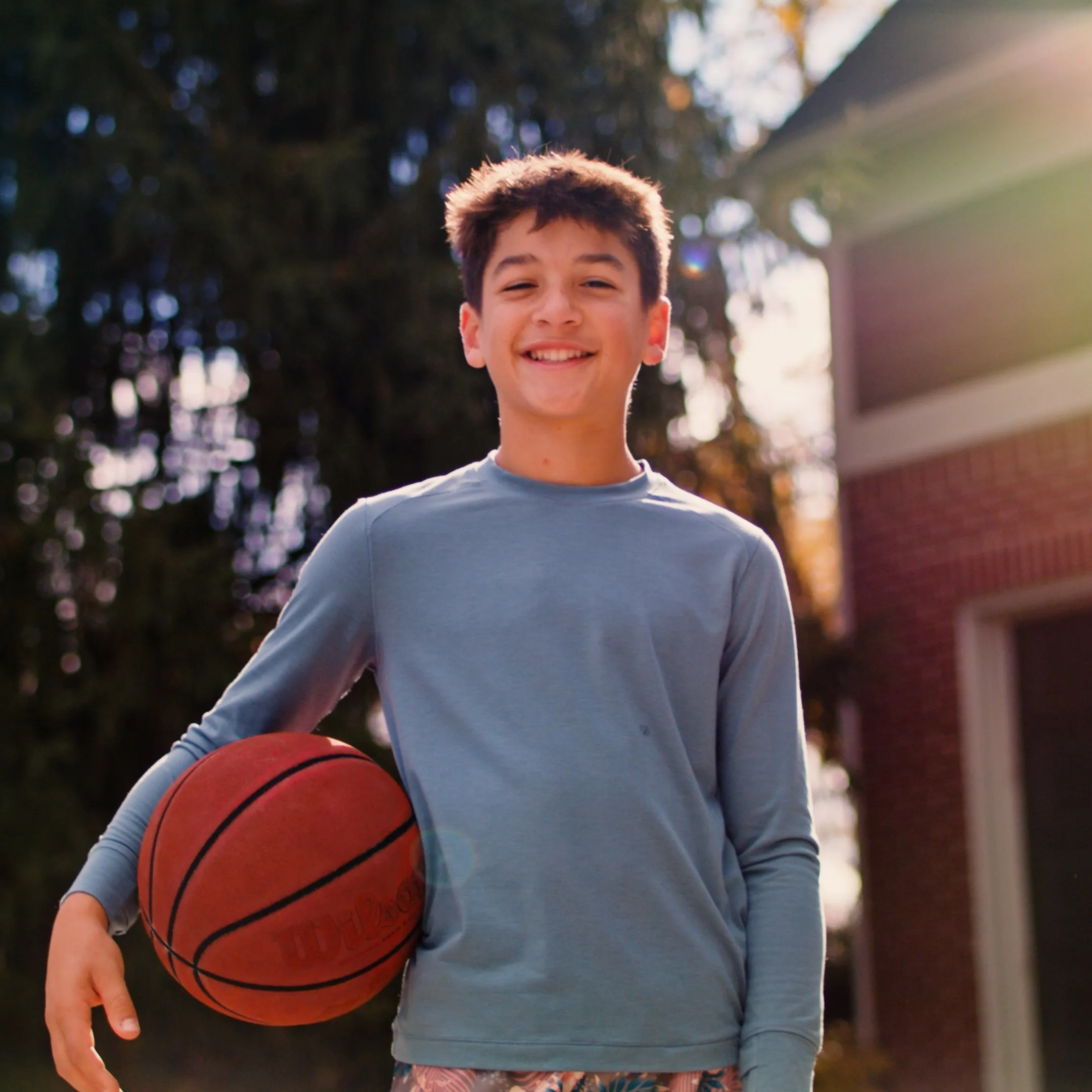 colin holds a basketball in his driveway