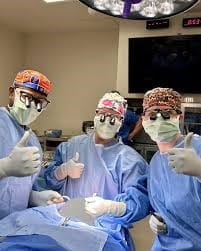2 Plastic surgery craniofacial faculty and fellow in OR
