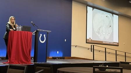 Dr. Dedent giving presentation on stage