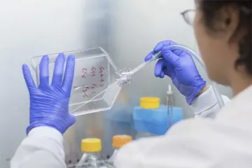 Scientist placing specimen in jar