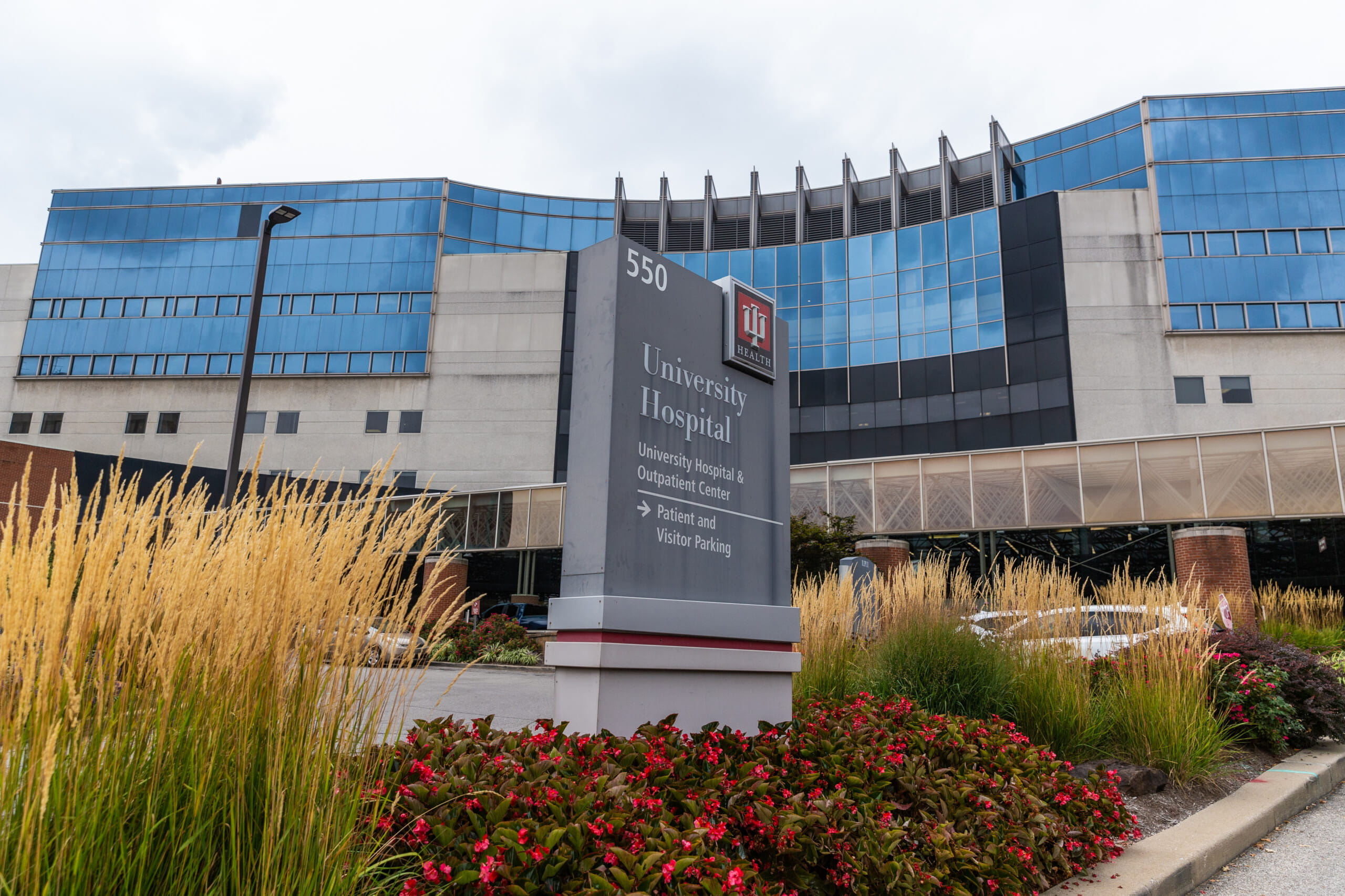 iu health university hospital exterior featuring blue glass and green landscaping