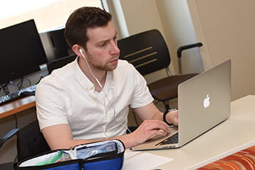 A student works on a laptop in class.