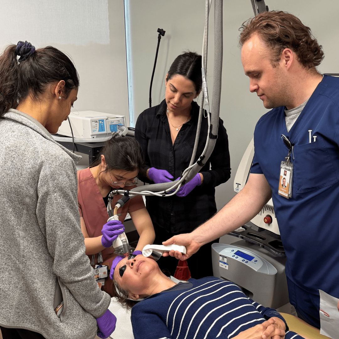 Dermatology Residents Ruple Jairath, Collin Evenson, Tiffany Cheng, and Cosmetics Director Janelle Nassim using the cosmetic laser on a patient in clinic