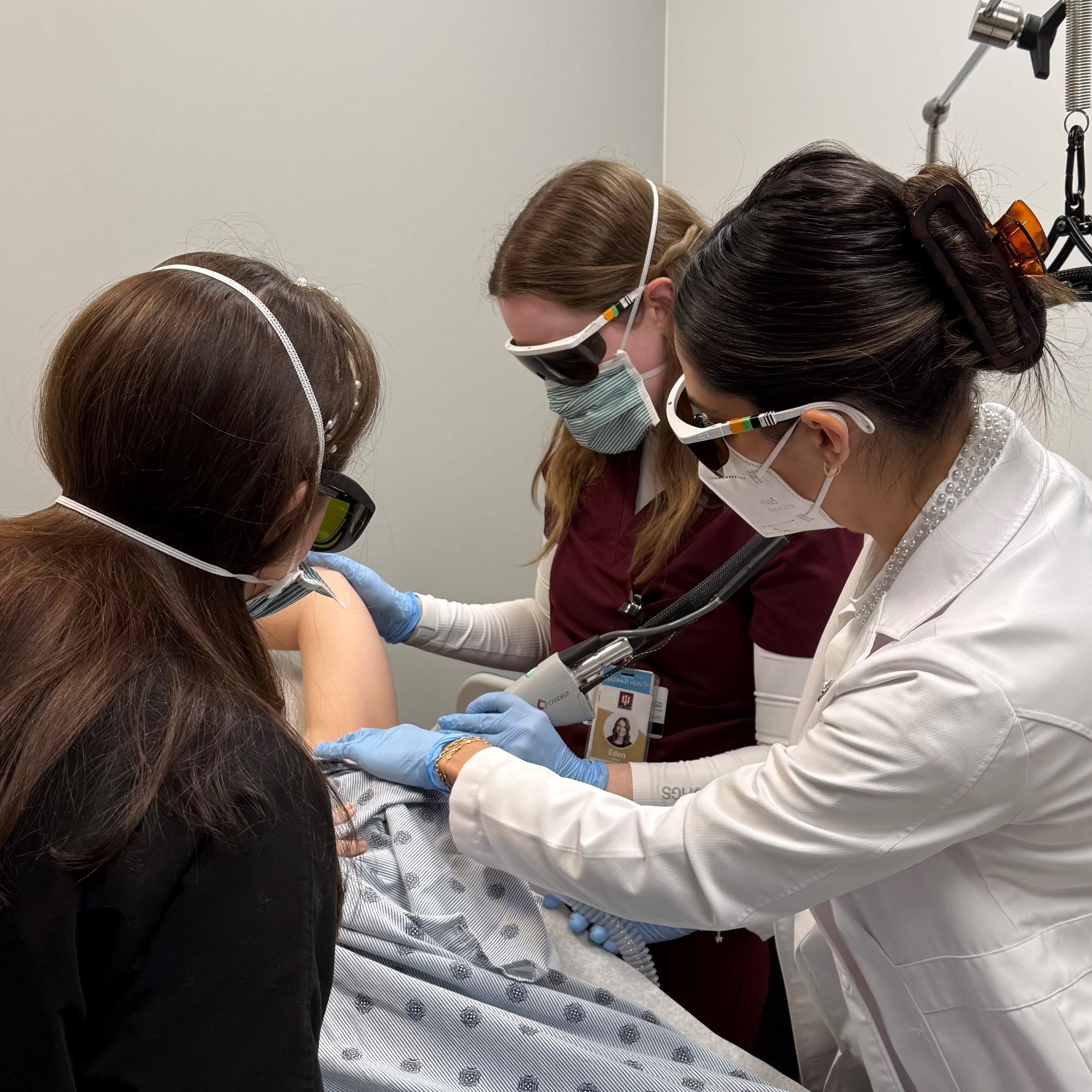 Dermatology Residents Anna Eden and Samantha Seward with Dr. Janelle Nassim during an examination