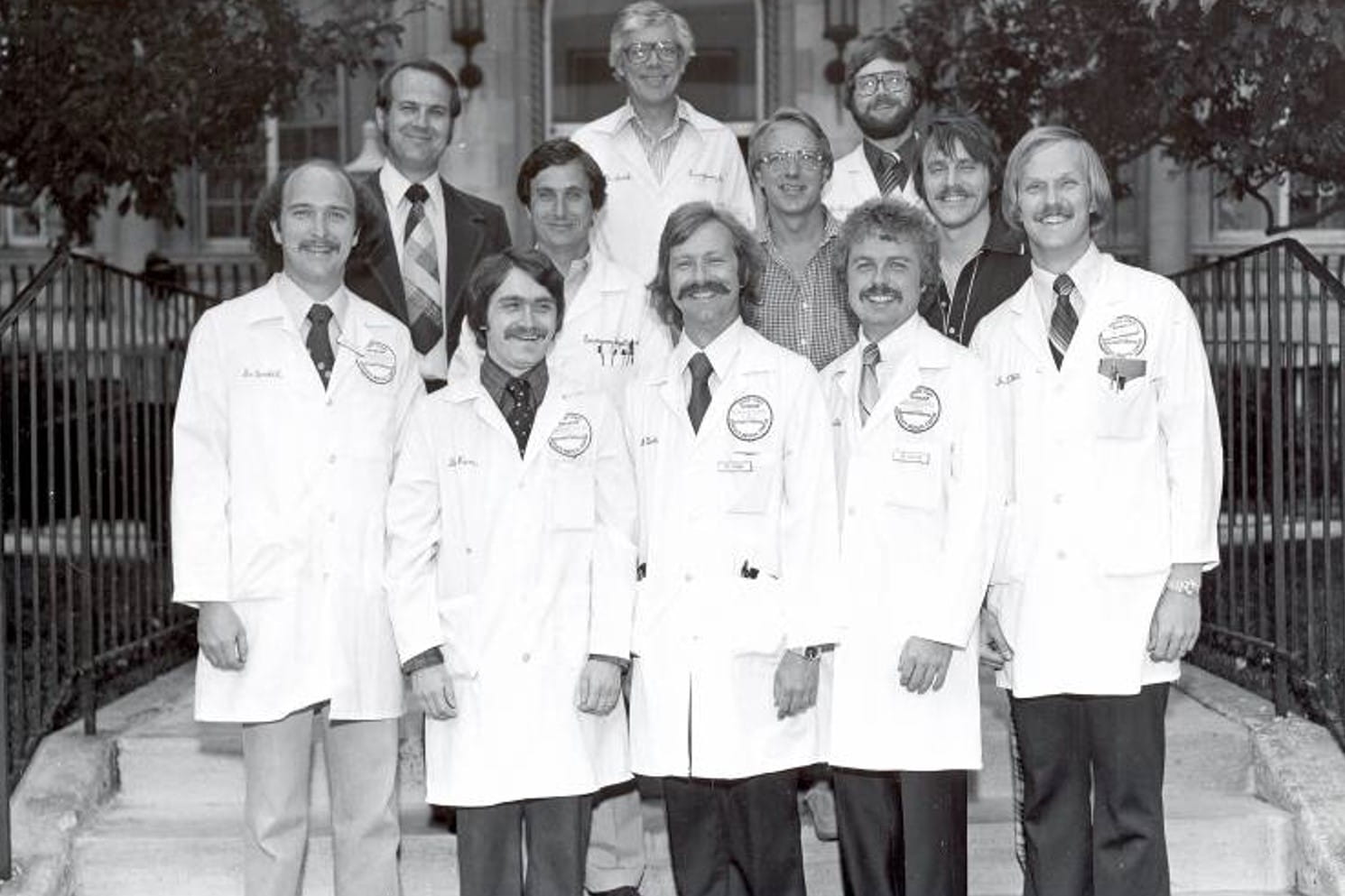 a black and white photo of the 11 members of the 1979 emergency medicine residency class