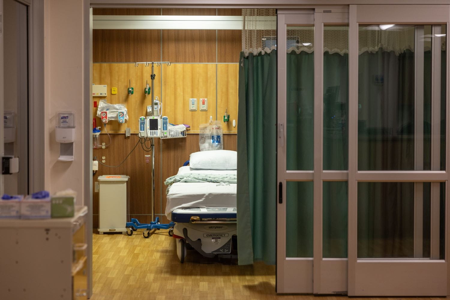 An empty emergency department room with the lights on. 