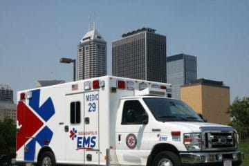 an ambulance in front of the indy skyline
