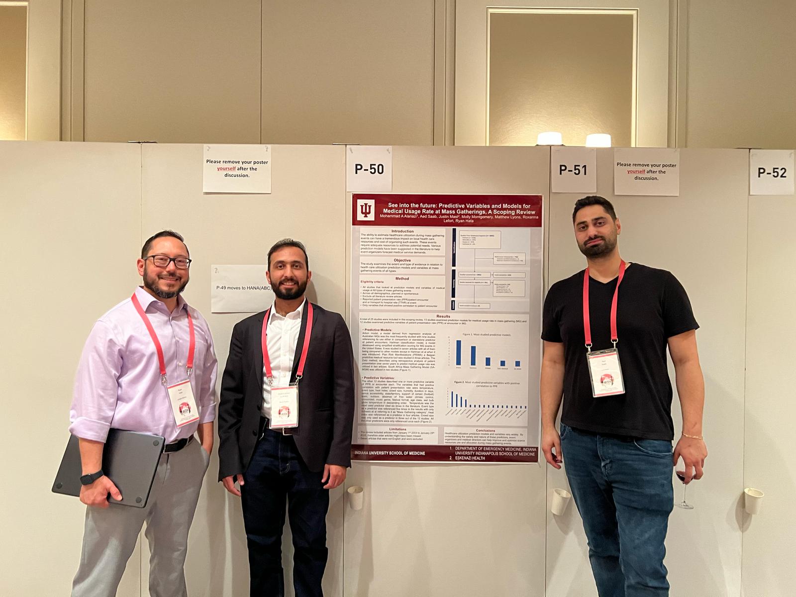 Fellows present research poster at a conference. 