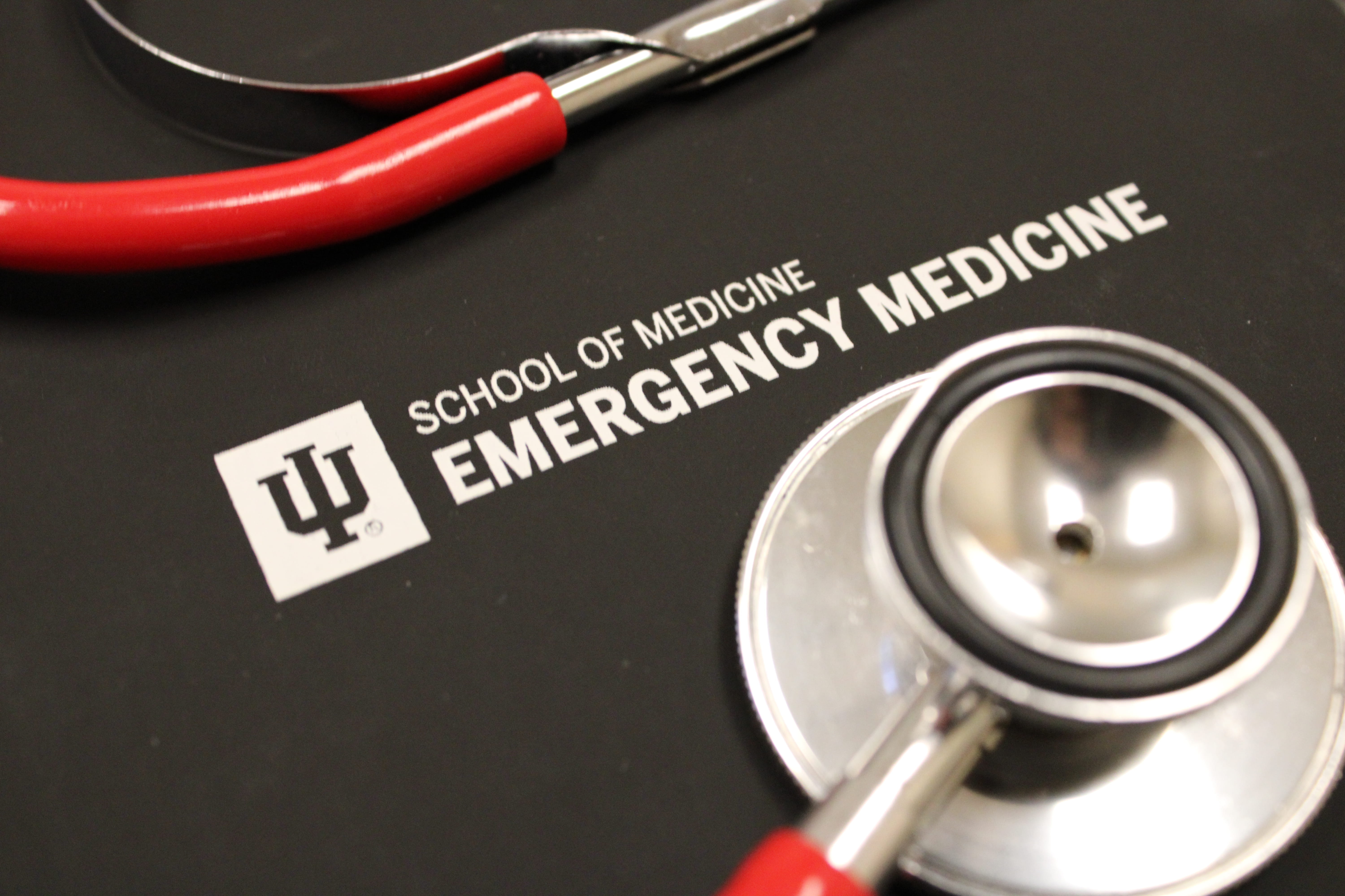 Stethoscope on a black notebook for the department logo. 
