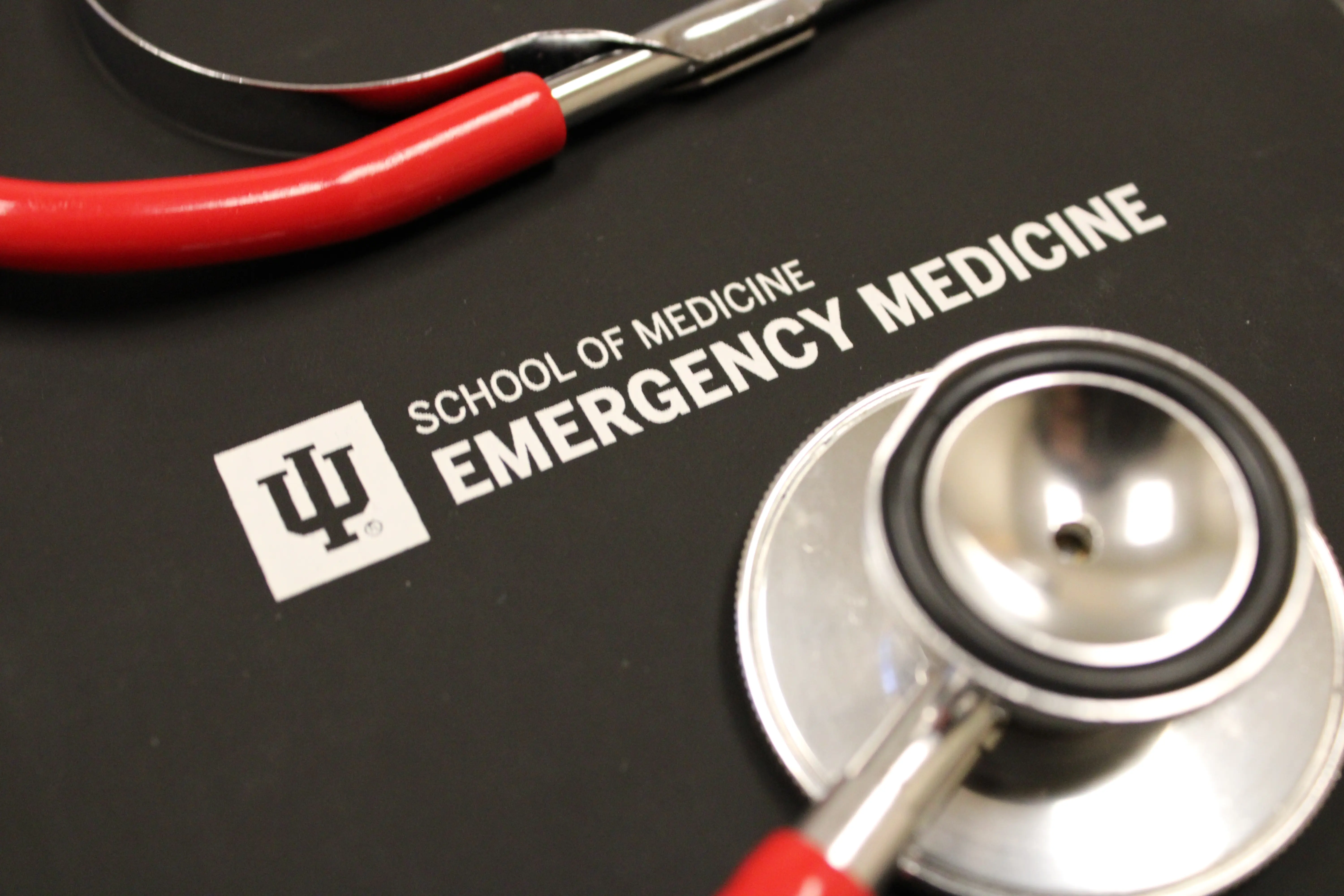 Stethoscope on a black notebook for the department logo. 