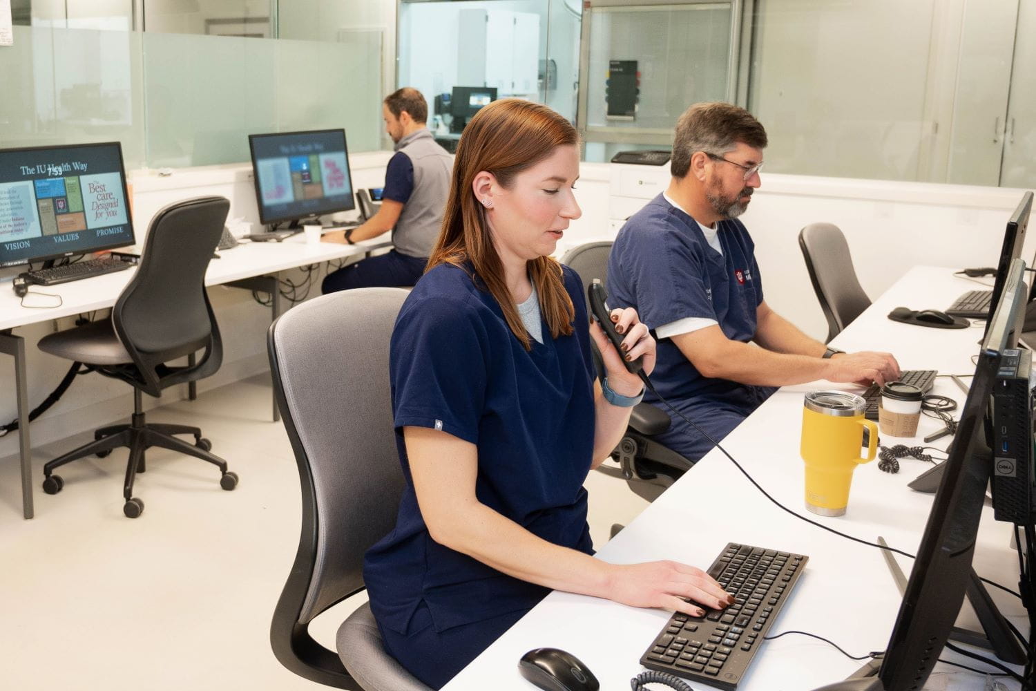 Faculty work at the computers in the emergency department.