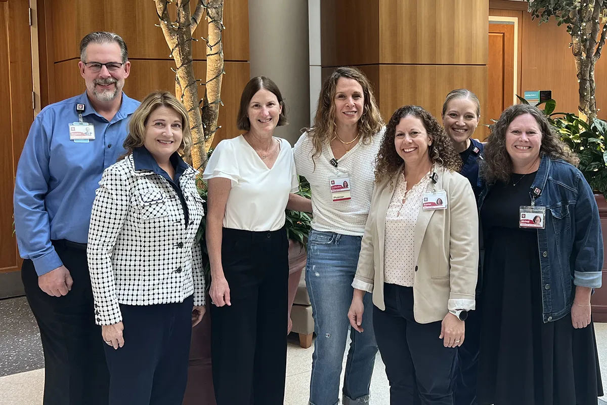 seven members of the litigation support team smile for a group photo