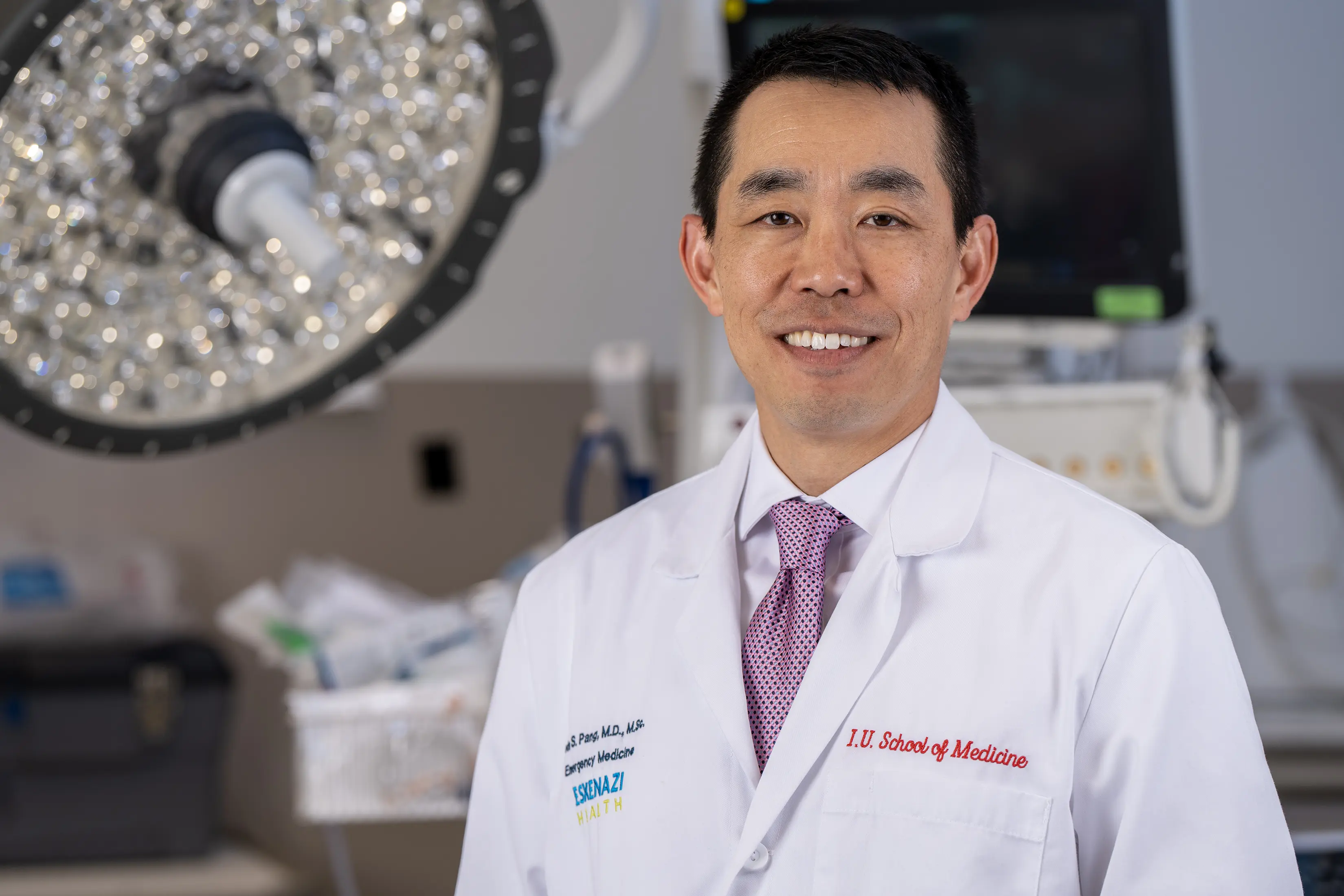 Dr. Peter Pang stands in the emergency department. 