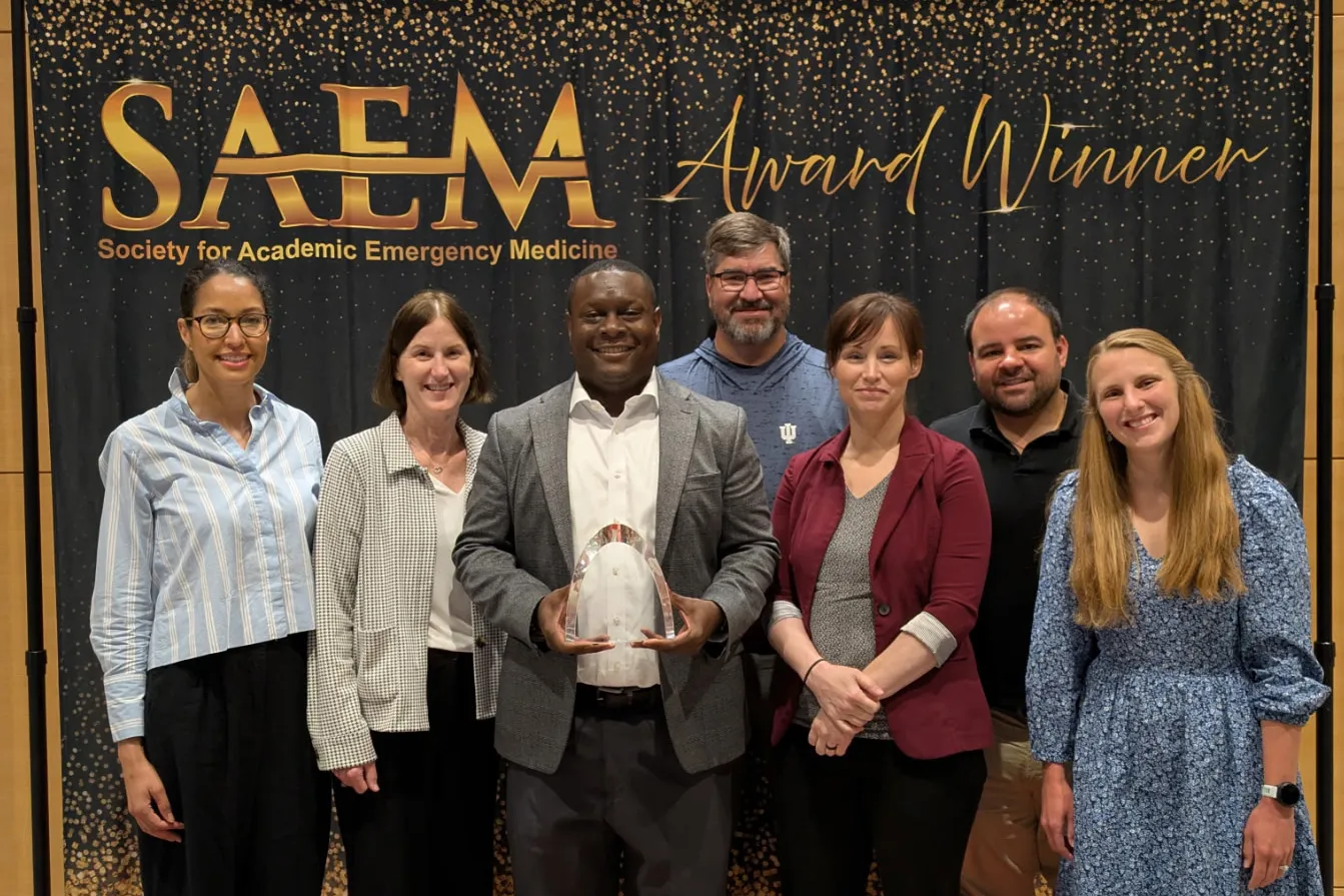 department leaders stand together for a group photo holding their award
