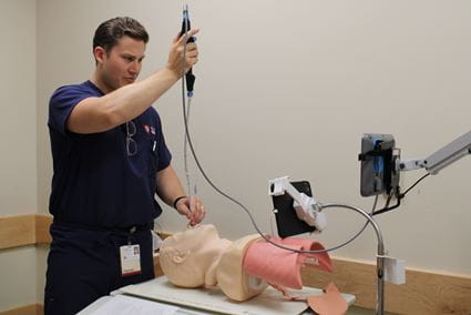 Emergency Medicine simulation Individual working with a scope in a simulation lab