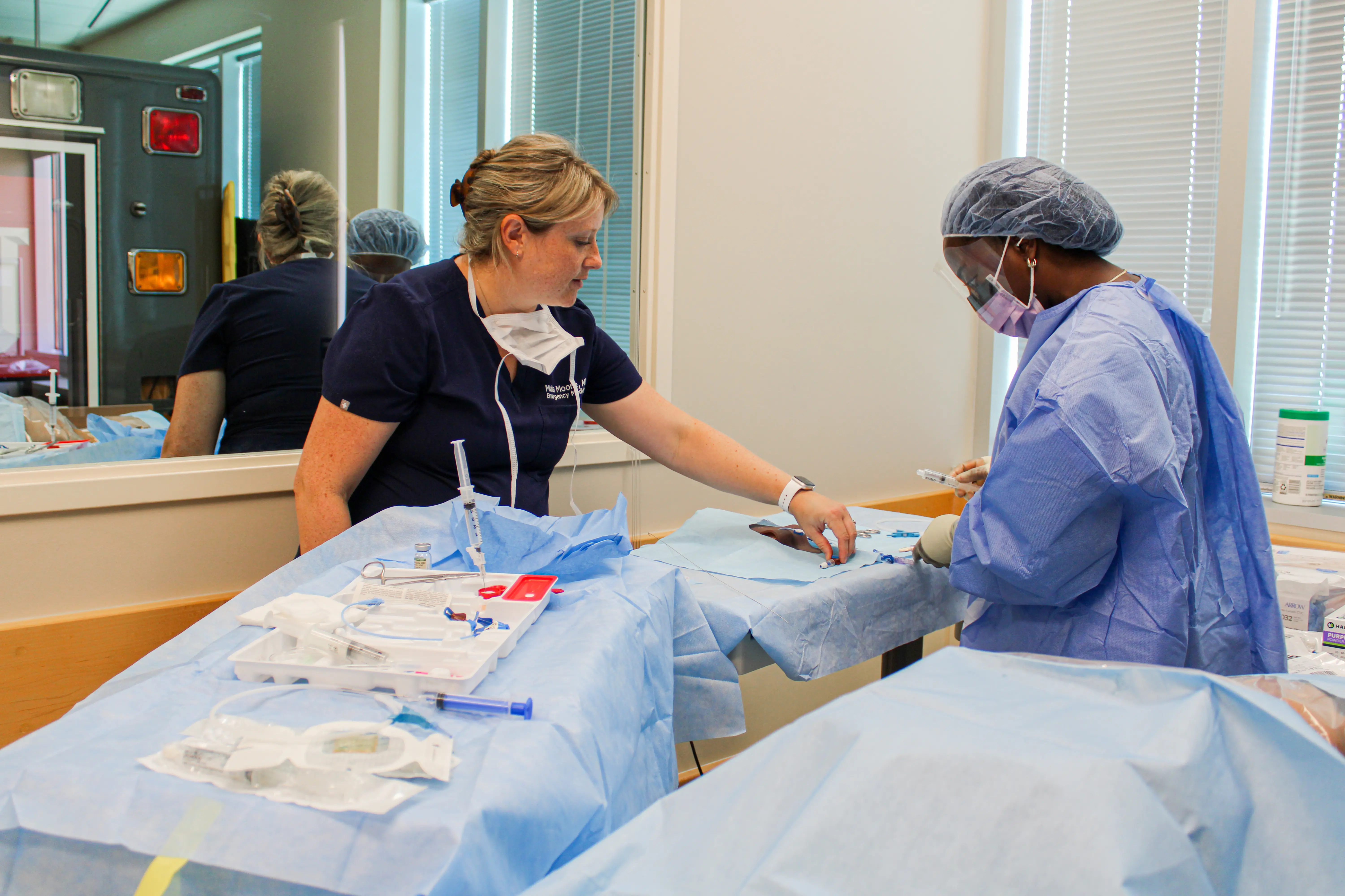 Dr. Malia Moore engages with a resident during a simulation procedure.