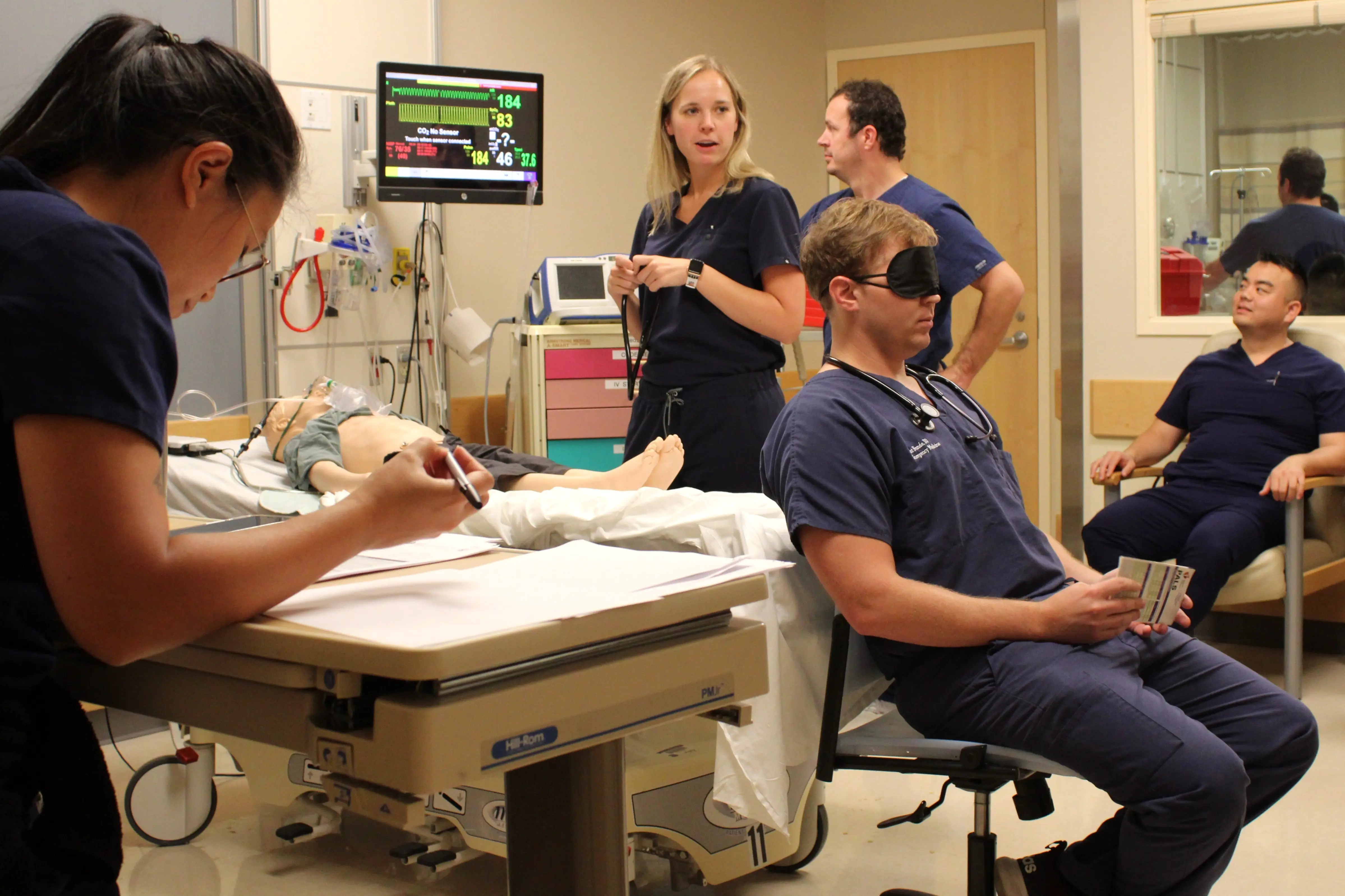 two fellows train with a manikin 