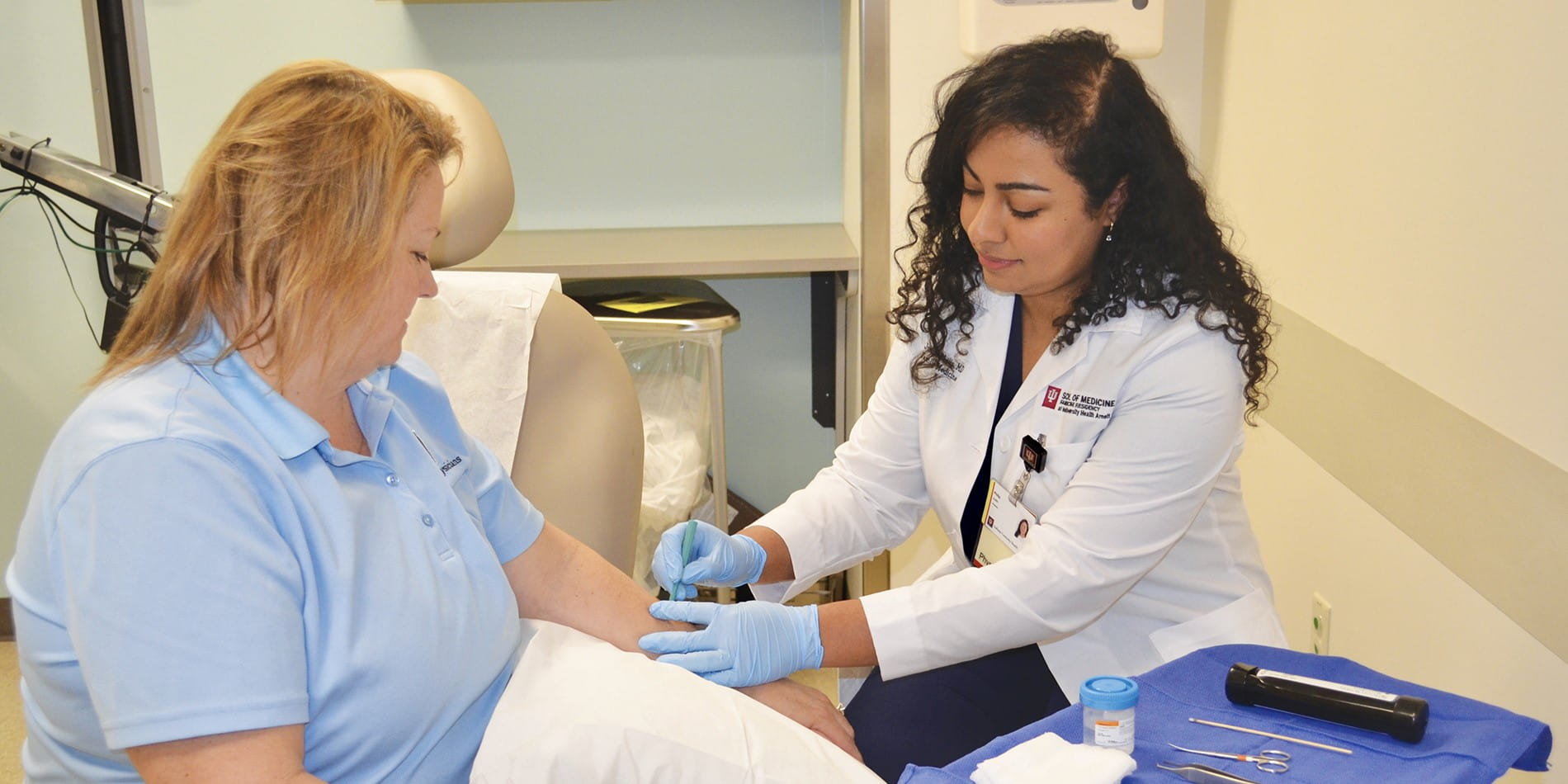 IU Arnett Family Medicine Resident performing procedure on patient.