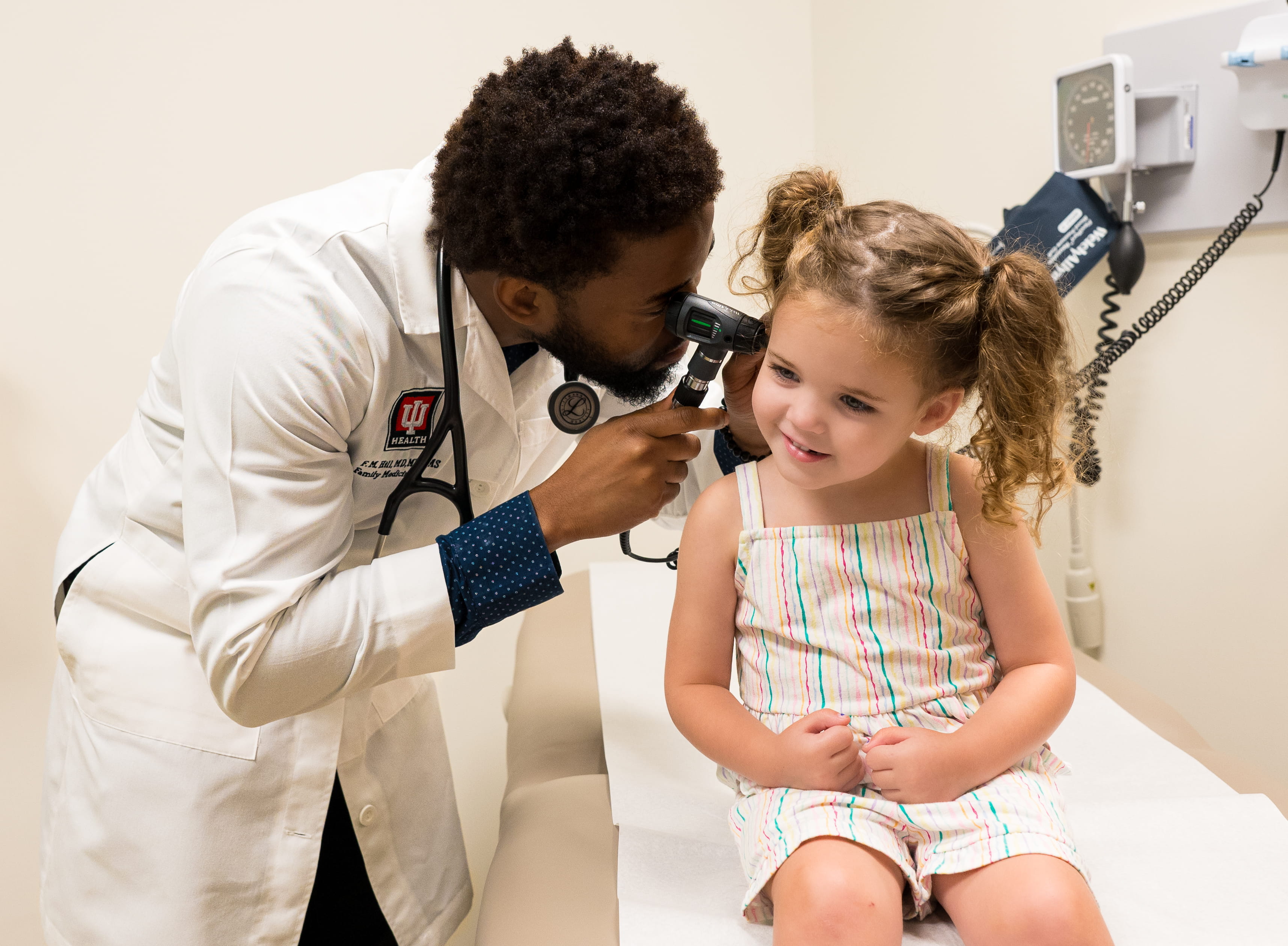 A resident examines a patient in the pediatric inpatient rotation